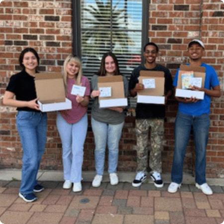 volunteers with the literacy kits they made