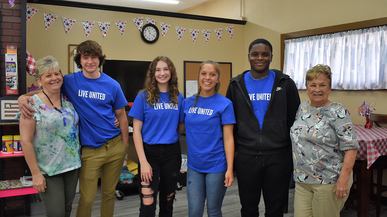 teen volunteers assisting at a senior center