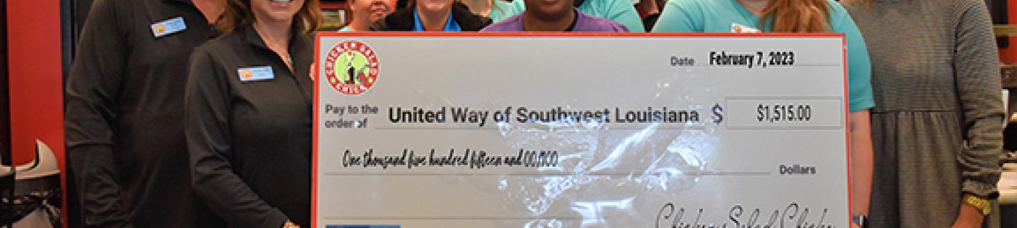 Chicken Salad Chick employees with big check
