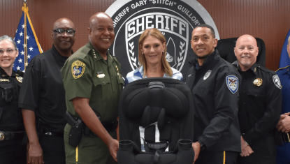 group of law enforcement with car seat